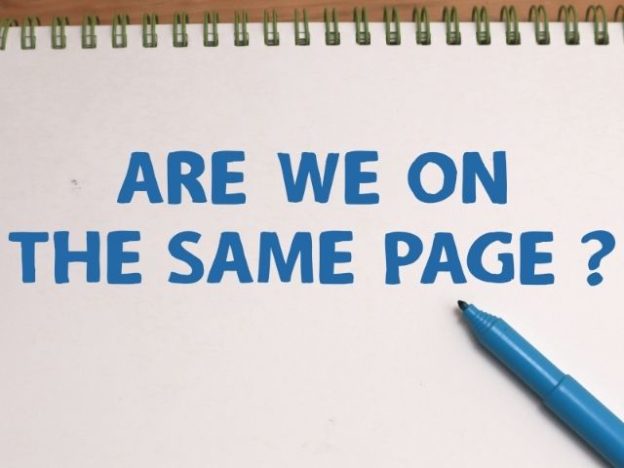 A pen and paper that says "are we on the same page?"