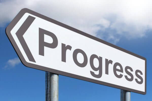 A road sign with the word progress written on it.