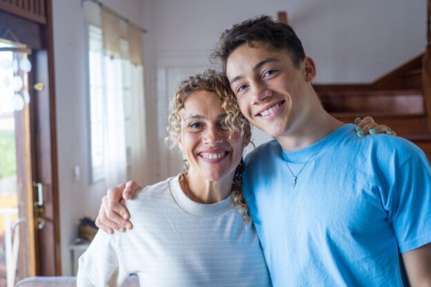 A teen after rehabilitation from substance use disorder, at home with his mother.